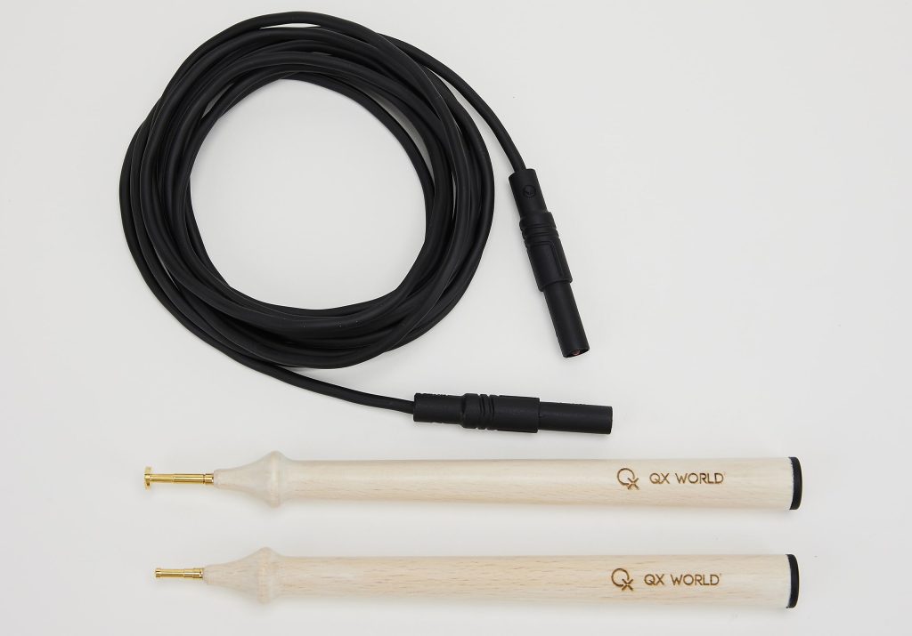 Audio cable and two drumsticks on white background