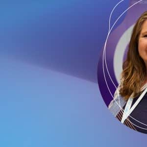 Smiling woman with badge on abstract blue background