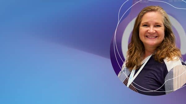 Smiling woman with badge on abstract blue background