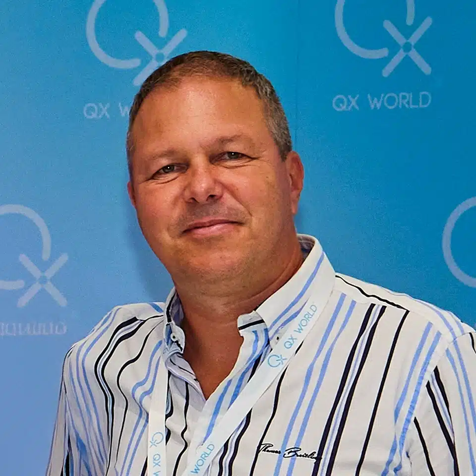 Man in striped shirt smiling at corporate event