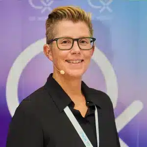 Smiling professional woman with microphone at conference