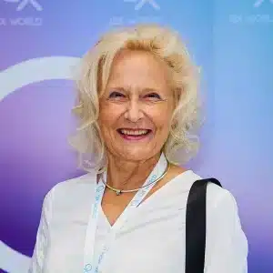 Smiling elderly woman at a conference event